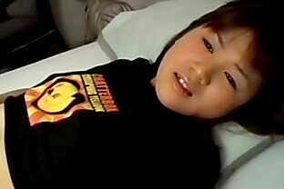 /images/An Asian girl is laying on her back on a bed, stroki from
